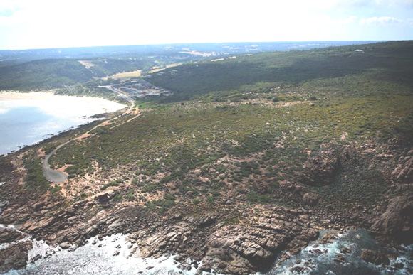 View from the cliffs at the western edge to the caravan park redevelopment site over the low coastal heath